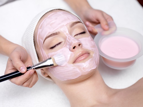 Young,Beautiful,Girl,Receiving,Pink,Facial,Mask,In,Spa,Beauty beauty and hair alons
